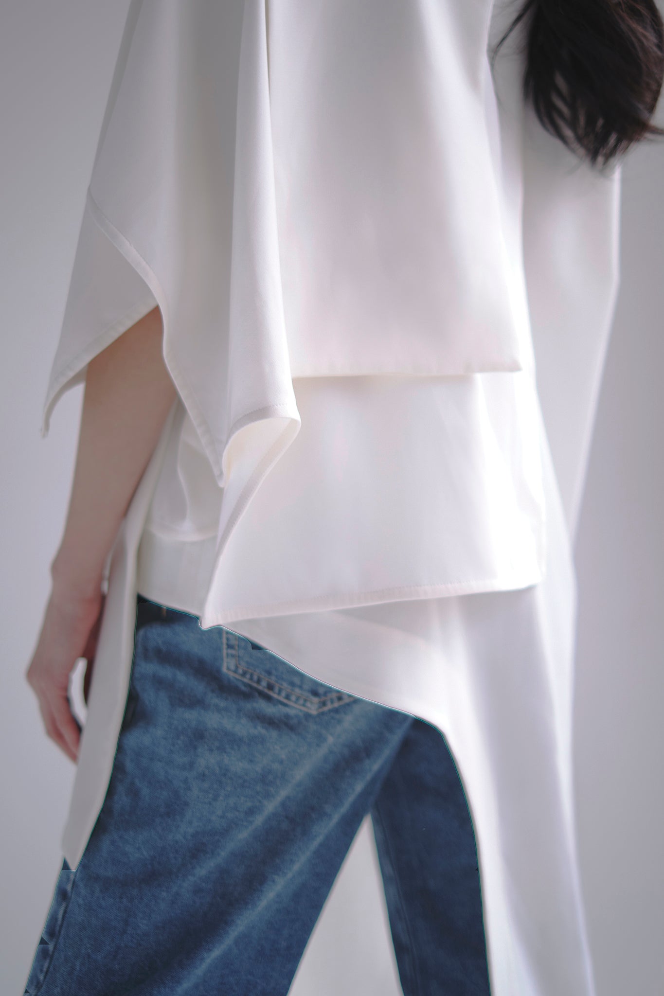Asymmetrical layered tunic with high neck in white