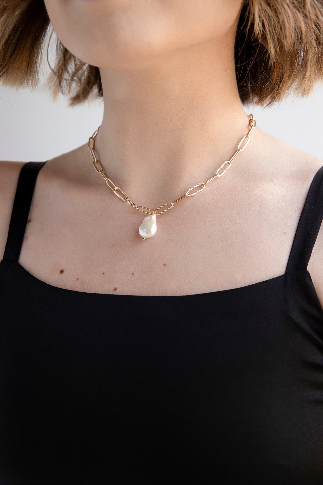 Gold flat chain choker with baroque pearl pendant