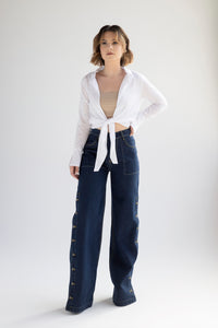 Wide leg denim trousers with side buttons in indigo