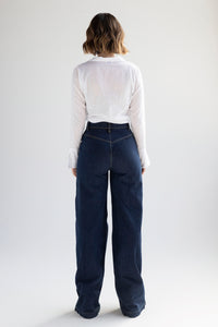 Wide leg denim trousers with side buttons in indigo