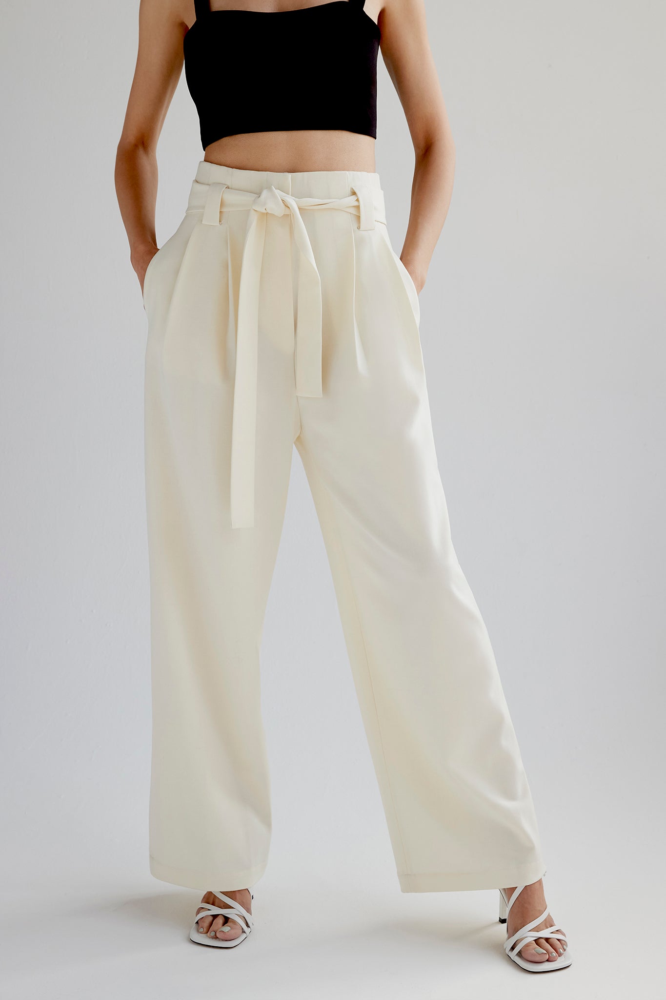 Belted cotton wide leg pleated pants in cream